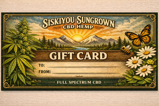 Siskiyou Sungrown CBD Hemp gift card with nature-themed design on a wooden surface.