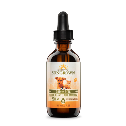 A bottle of CBD salmon oil for pets with a dropper, labeled with 200mg of CBD and an image of a dog and a cat.